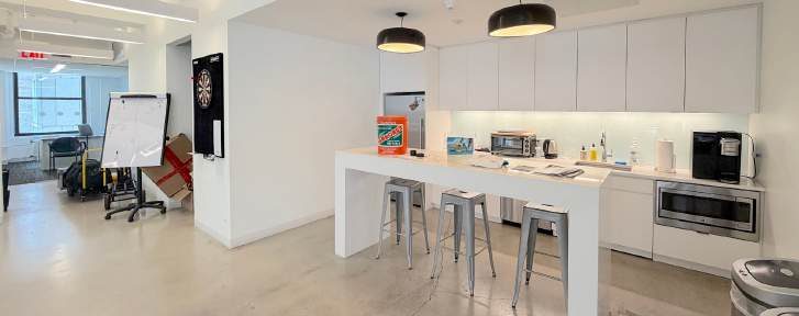 Kitchen with white cabinetry and a breakfast bar with stools
