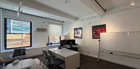 Private office with a desk and a window
