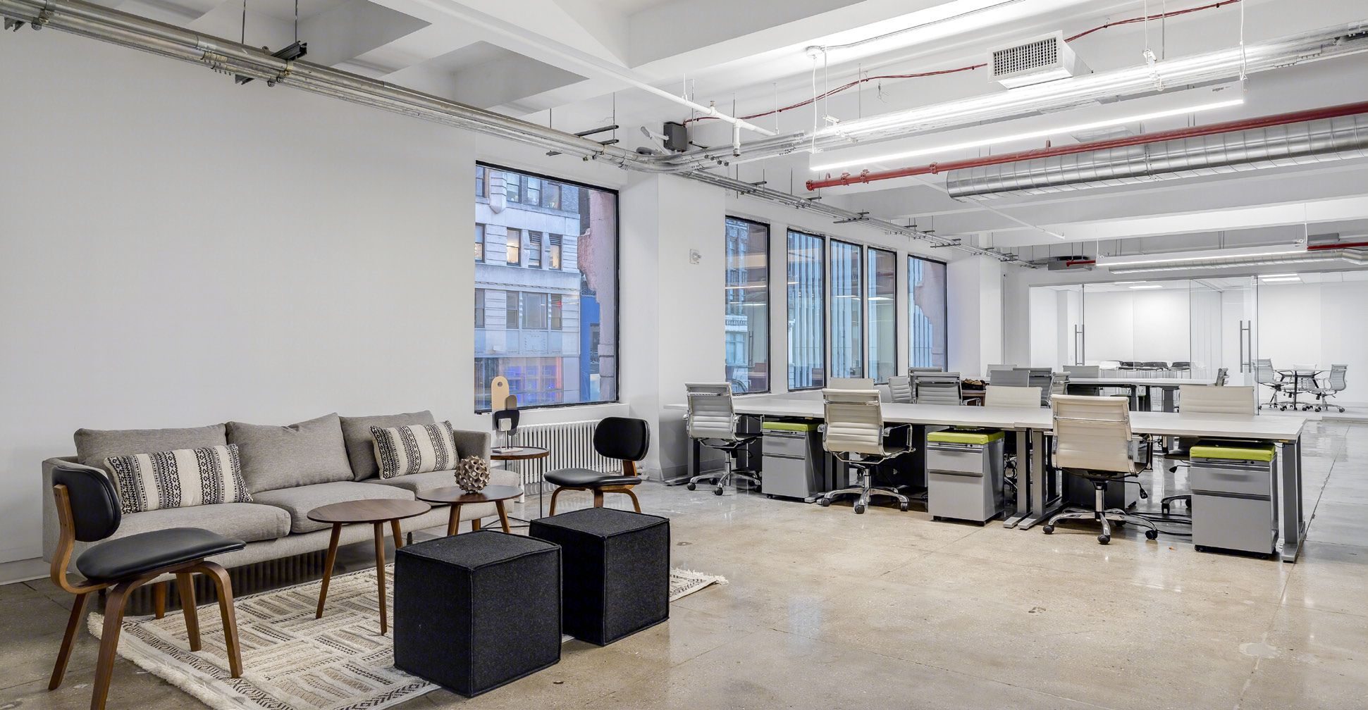 Lounge seating in front of open workstations