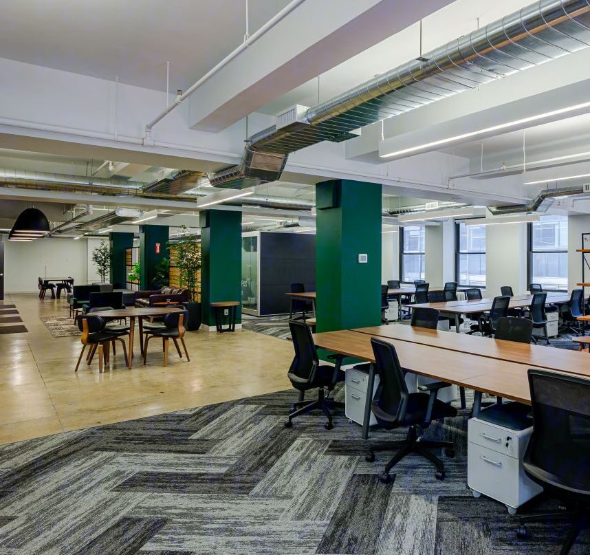 Open plan office with cafe seating and bench desks